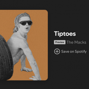 Picture of man painted white with sunglasses climbing out of a tire tunnel to promote The Macks new song "Tiptoes"